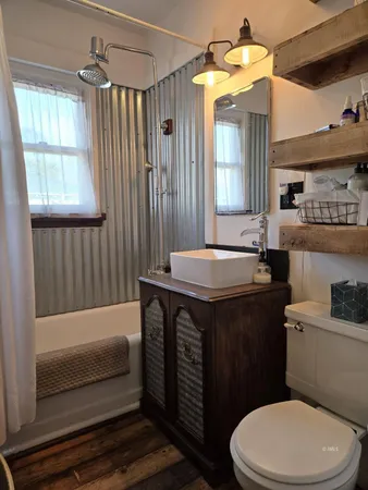 a bathroom with a sink toilet and shower