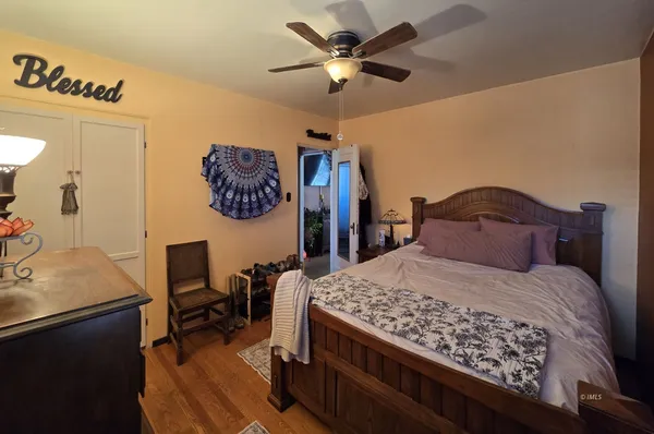 a bedroom with a bed a desk and chair