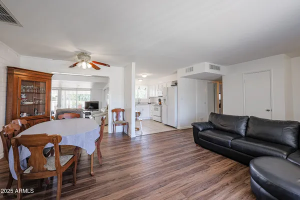 a living room with furniture and wooden floor