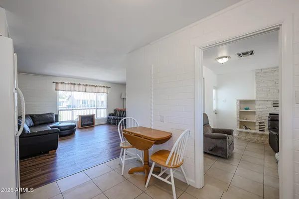 a living room with furniture and kitchen view