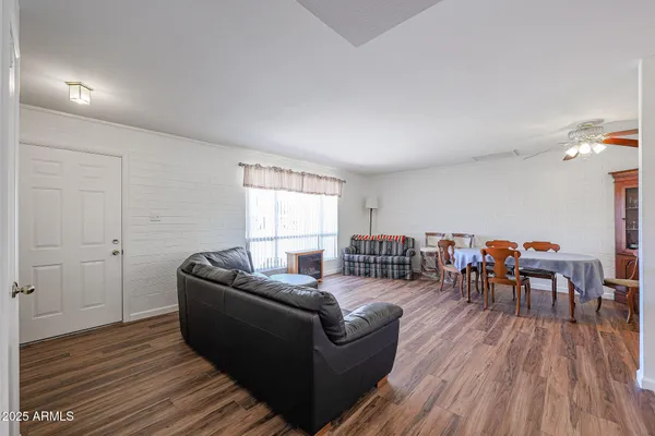 a living room with furniture and a wooden floor