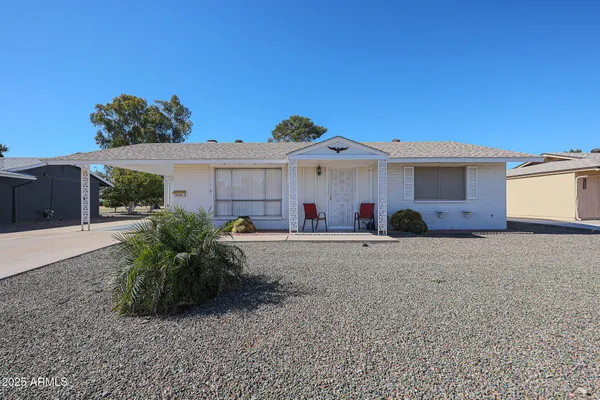 a front view of a house with a yard and a garage