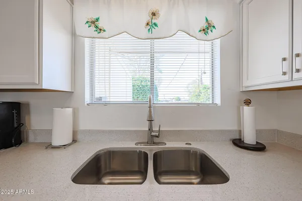 a kitchen with a sink and a window
