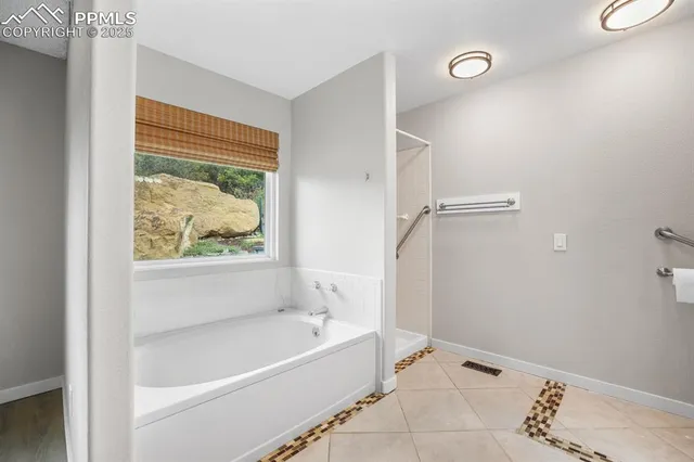 a bathroom with a bathtub and shower
