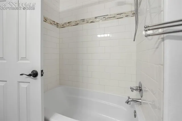 a bathroom with a shower and a bath tub