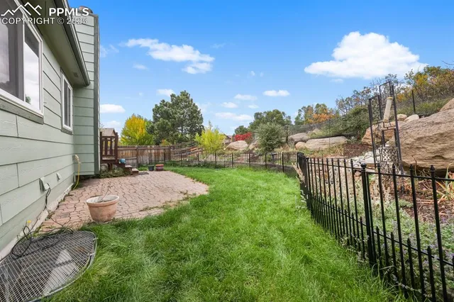 a view of a wrought iron fences in front of yard