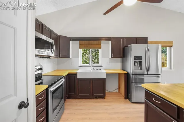a kitchen with a refrigerator and a stove