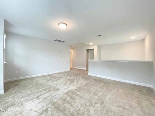 an empty room with windows and ceiling fan view