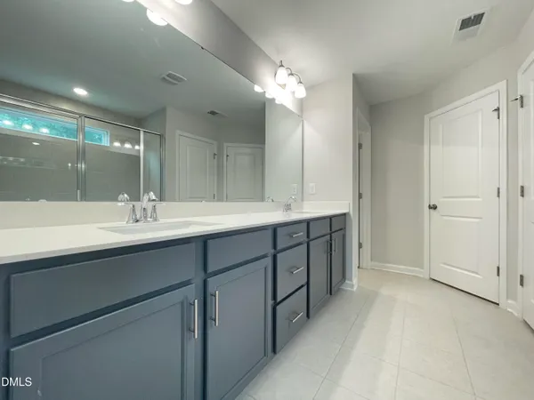 a bathroom with a glass shower door and a glass door shower