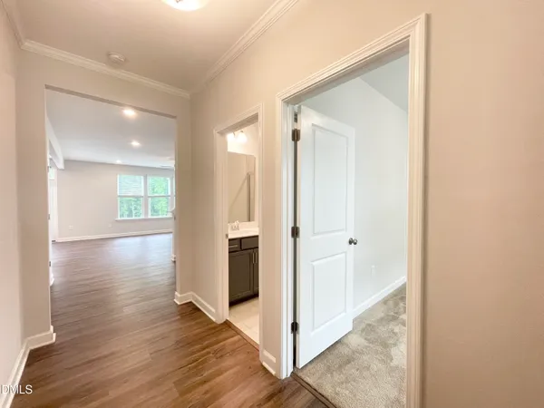 a view of a hallway with wooden floor