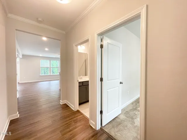 a view of a hallway with wooden floor