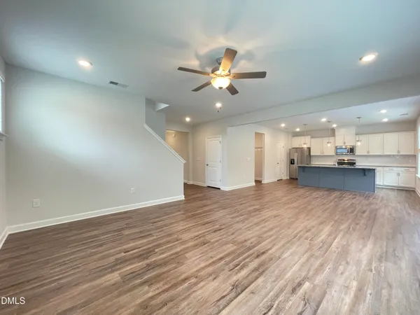 a large kitchen with stainless steel appliances granite countertop a lot of counter space