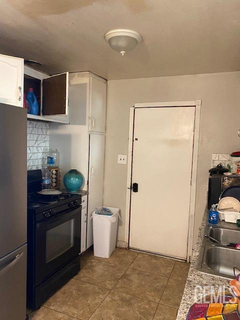 Undisclosed Address Bakersfield, CA 93307 - Photo 5 of 9 a kitchen with stainless steel appliances a stove a microwave and cabinets