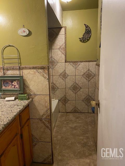 Undisclosed Address Bakersfield, CA 93307 - Photo 6 of 9 a bathroom with a granite countertop sink and a mirror