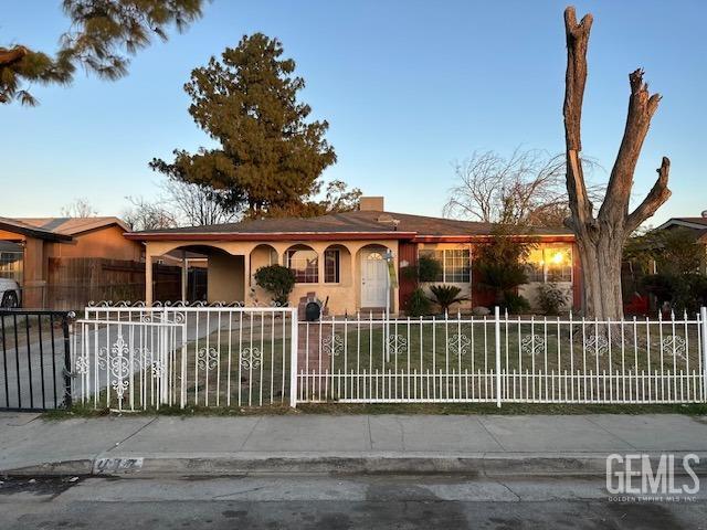Undisclosed Address Bakersfield, CA 93307 - Photo 9 of 9 a front view of a house with a garden and plants
