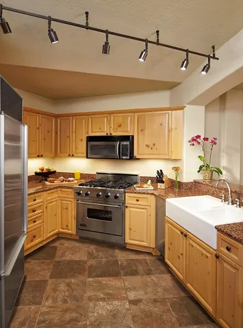 a kitchen with a stove top oven sink and cabinets