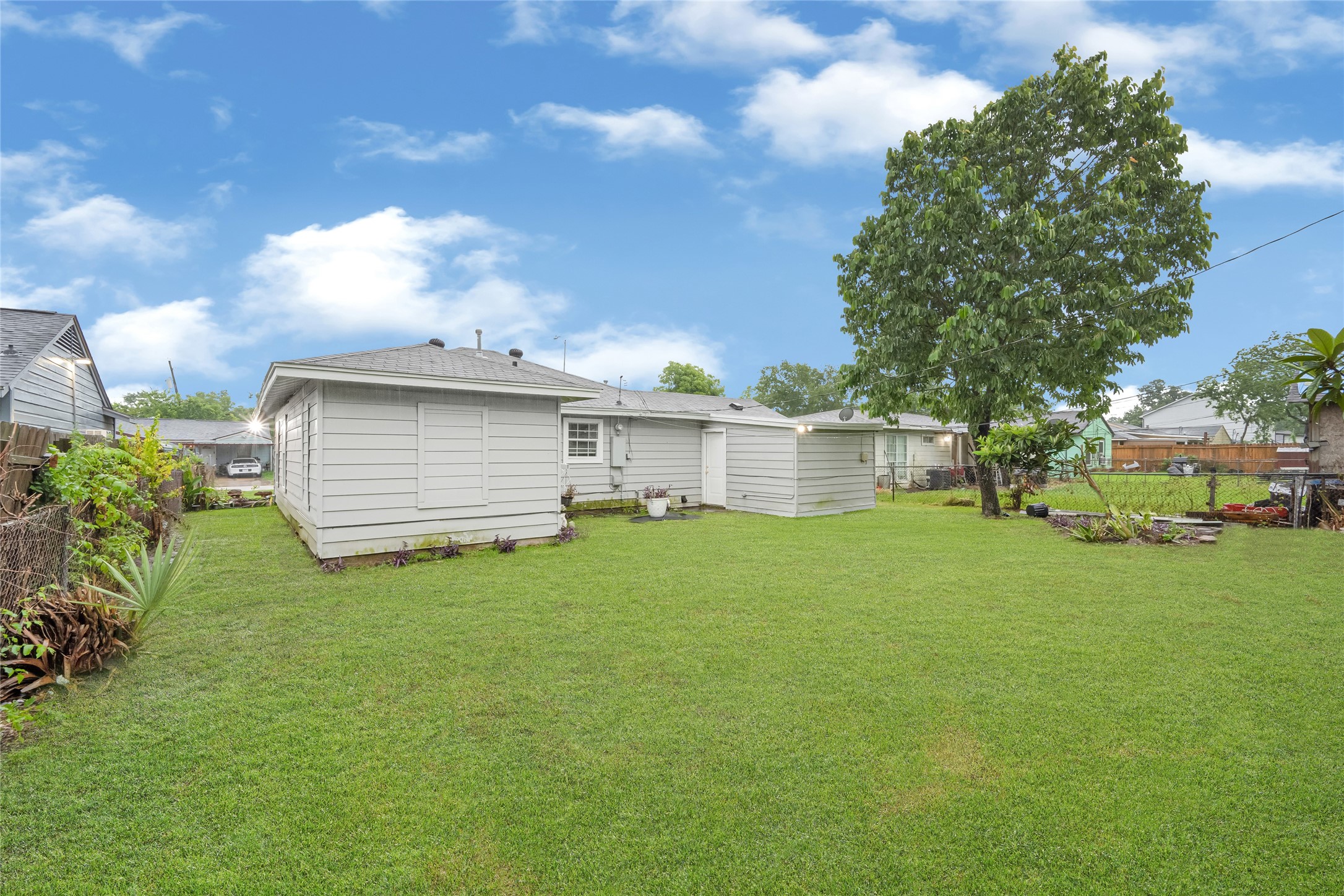 5009 Bataan Road Houston, TX 77033 - Photo 6 of 24 a view of a backyard with grass and a large tree