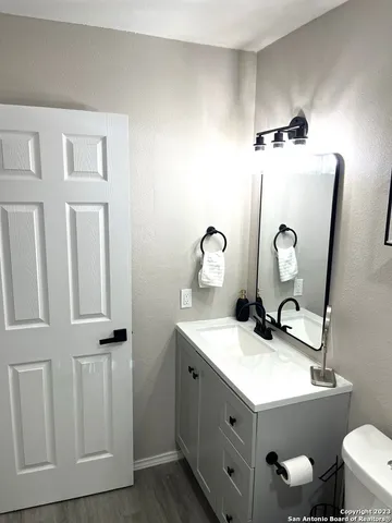 a bathroom with a sink toilet and mirror