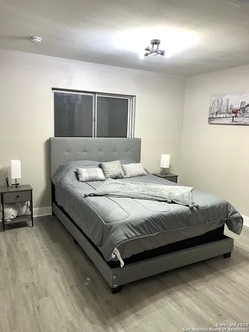 a bedroom with a bed and a night stand