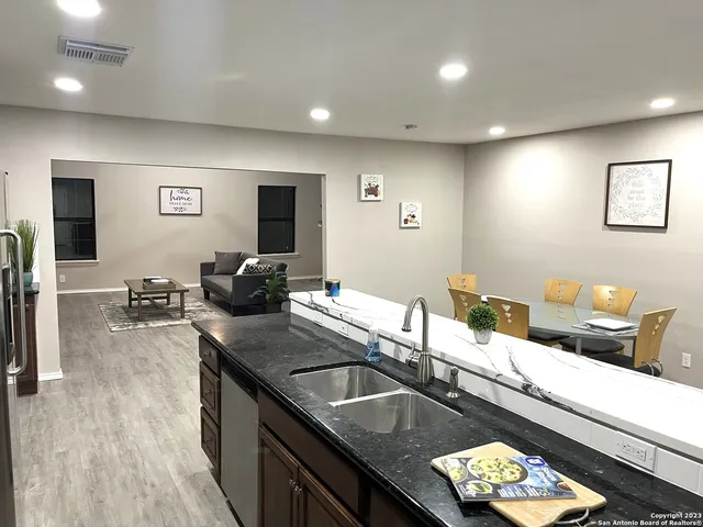 a kitchen with a sink and living room
