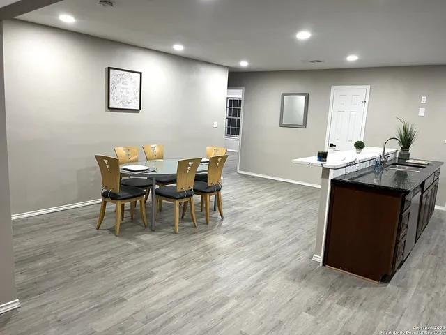 a view of a dining room with furniture and wooden floor