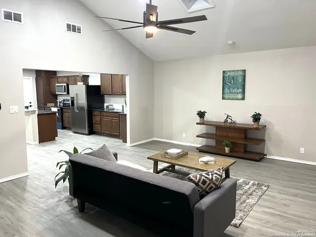 a living room with furniture and flat screen tv