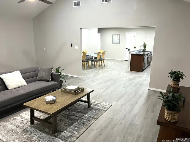 a living room with furniture and wooden floor