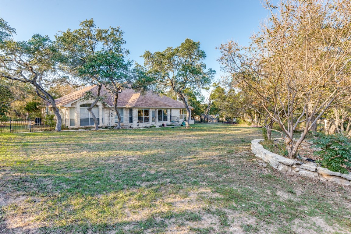 6901 Bright Star Lane Austin, TX 78736 - Photo 2 of 24 a view of house with garden space and trees in the background