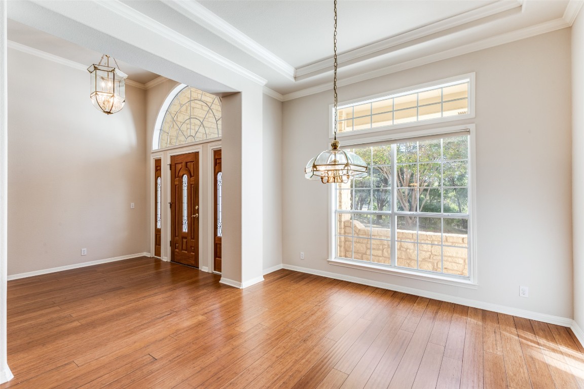 6901 Bright Star Lane Austin, TX 78736 - Photo 3 of 24 a view of an empty room with wooden floor and a window