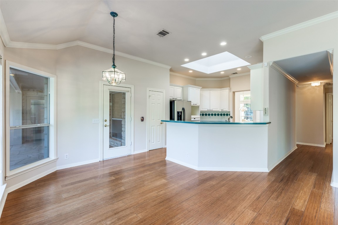 6901 Bright Star Lane Austin, TX 78736 - Photo 9 of 24 a view of a kitchen with granite countertop wooden floor and a refrigerator