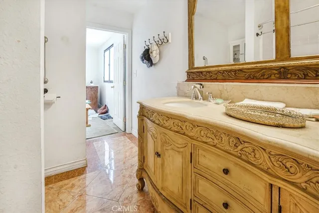 a bathroom with a sink vanity and mirror