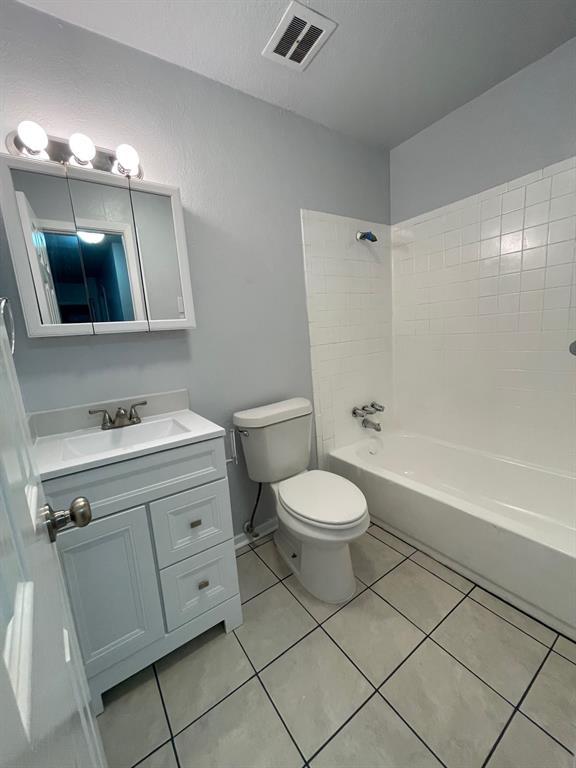 738 East Oates Road Garland, TX 75043 - Photo 13 of 19 a bathroom with a toilet sink and mirror