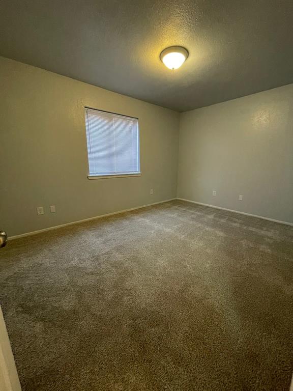 738 East Oates Road Garland, TX 75043 - Photo 14 of 19 an empty room with a empty space and a window