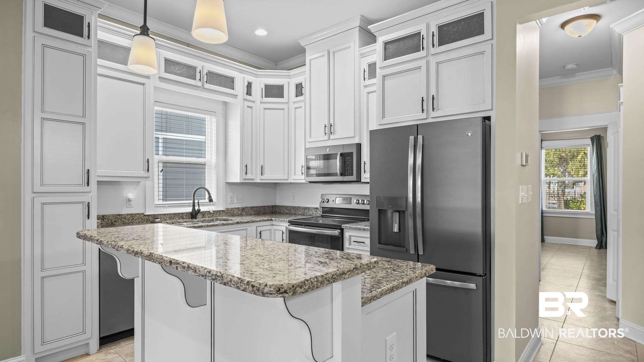 12361 Reunion Place Foley, AL 36535 - Photo 12 of 43 Kitchen featuring glass insert cabinets, appliances with stainless steel finishes, crown molding, light stone counters, and white cabinetry