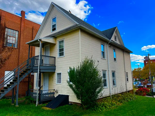 a view of house with a yard
