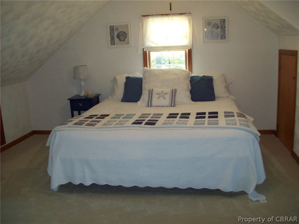 195 Hurst Neck Road Onemo, VA 23130 - Photo 27 of 30 a bed sitting in a bedroom next to a window