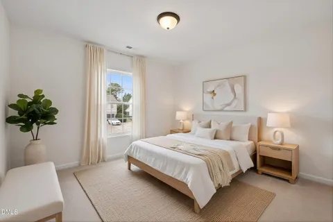 a bedroom with a bed and a potted plant