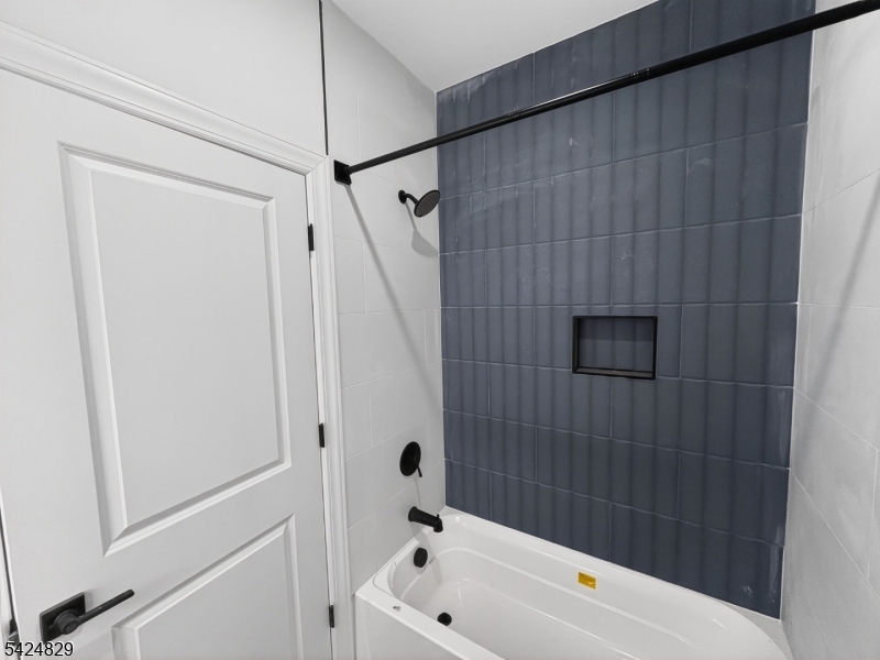 262 Hunterdon Street, Unit 1 Newark, NJ 07103 - Photo 4 of 31 a bathroom with a bathtub and a shower