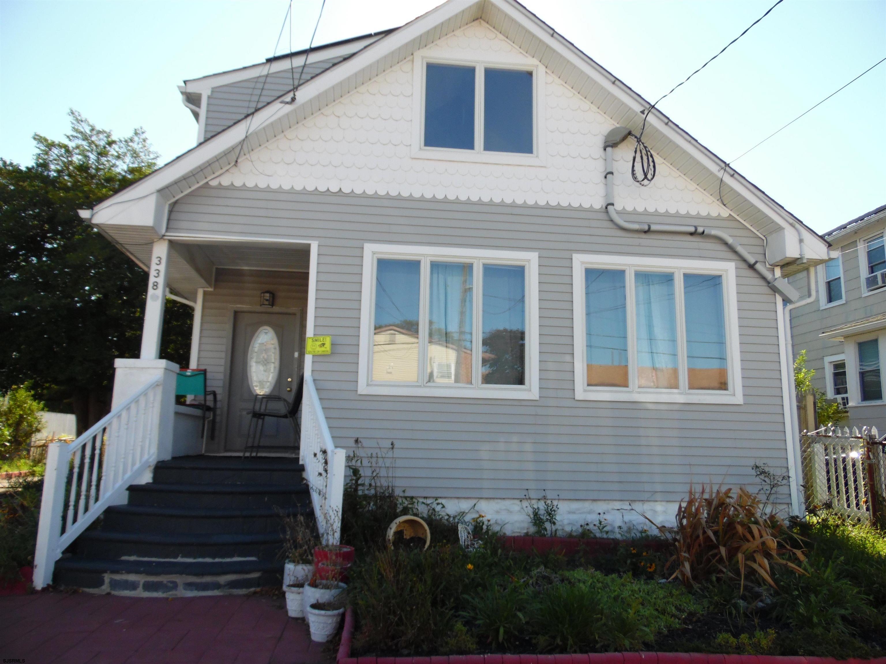 a front view of a house with stairs