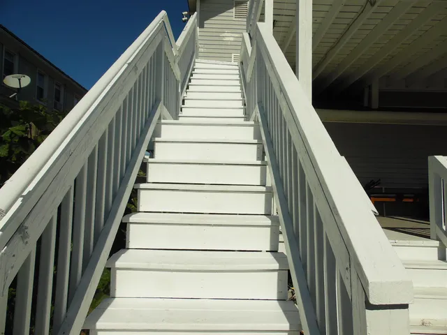 a kitchen with a table chairs refrigerator and microwave
