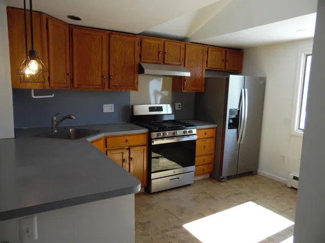 a kitchen with a sink and a stove top oven