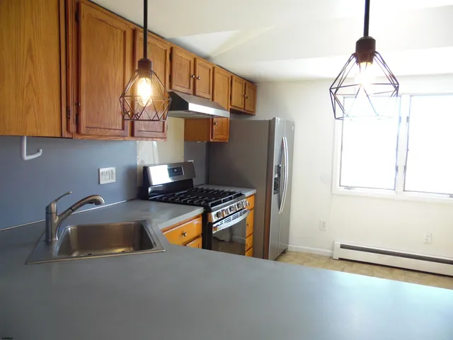 a view of a dining room with furniture wooden floor and chandelier