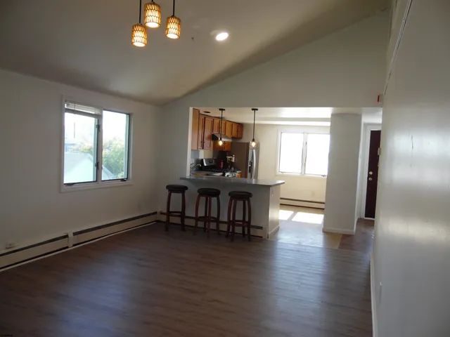 a kitchen with stainless steel appliances a refrigerator and a stove top oven