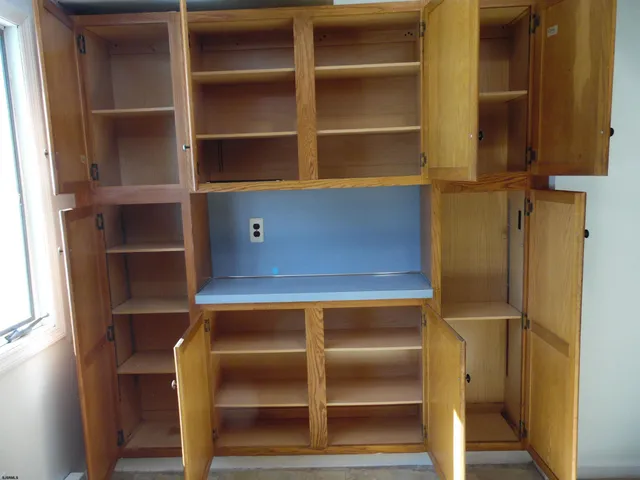 a view of a room with wooden floor and window