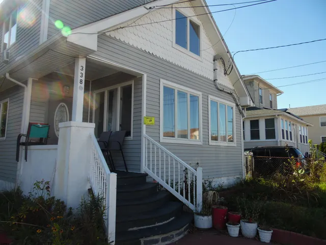 a view of a house with more potted plants