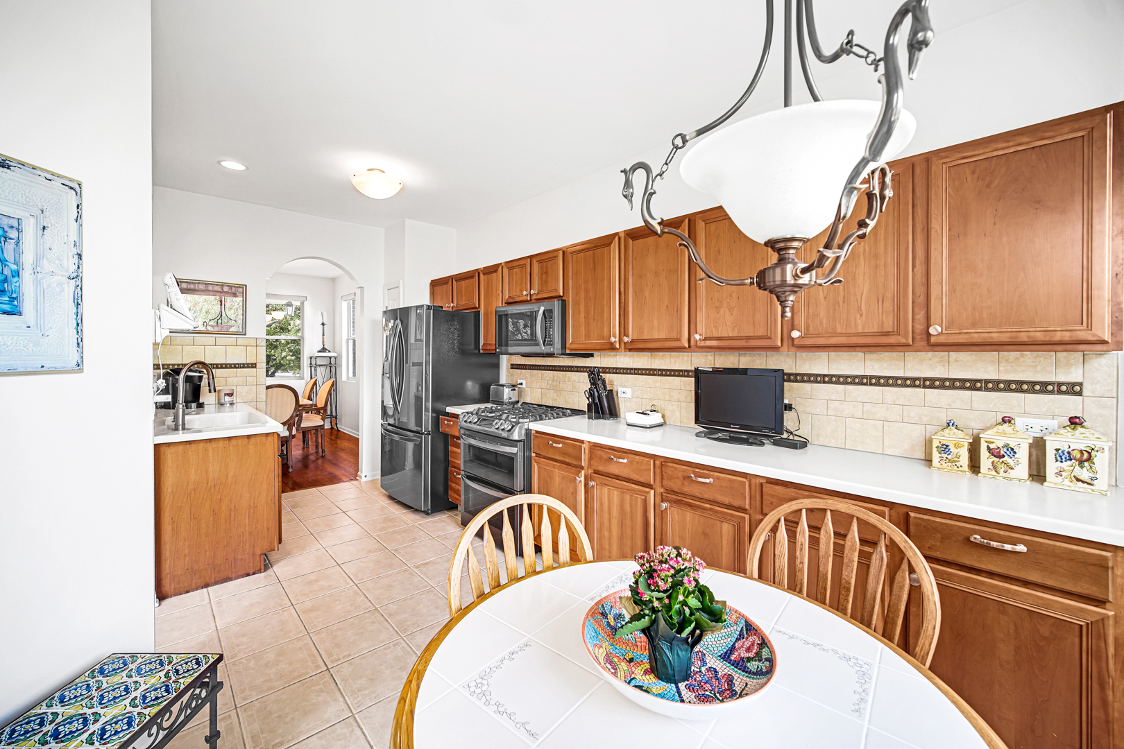 726 St Johns Place Addison, IL 60101 - Photo 11 of 39 a kitchen with stainless steel appliances kitchen island granite countertop a sink a stove and cabinets