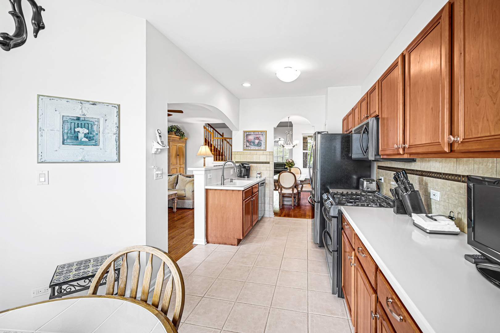 726 St Johns Place Addison, IL 60101 - Photo 12 of 39 a kitchen with a refrigerator and a sink