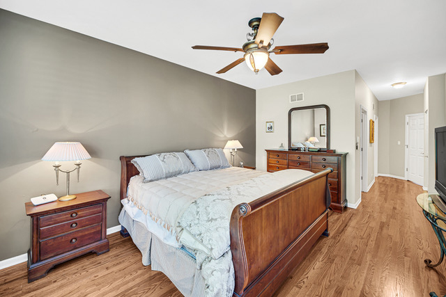 726 St Johns Place Addison, IL 60101 - Photo 16 of 39 a bed room with a bed and a chandelier
