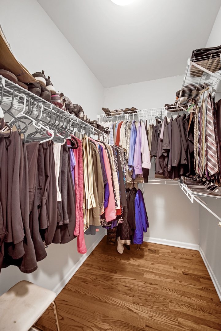 726 St Johns Place Addison, IL 60101 - Photo 19 of 39 a view of walk in closet with clothes