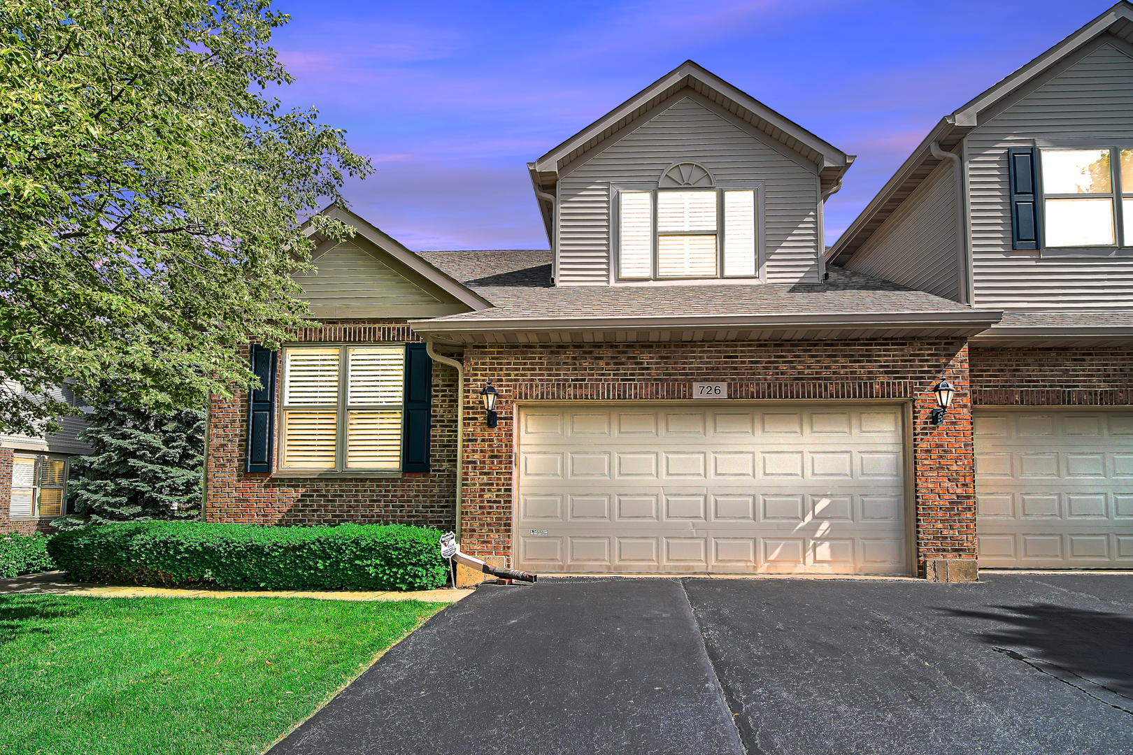 726 St Johns Place Addison, IL 60101 - Photo 2 of 39 a front view of a house with a yard and garage
